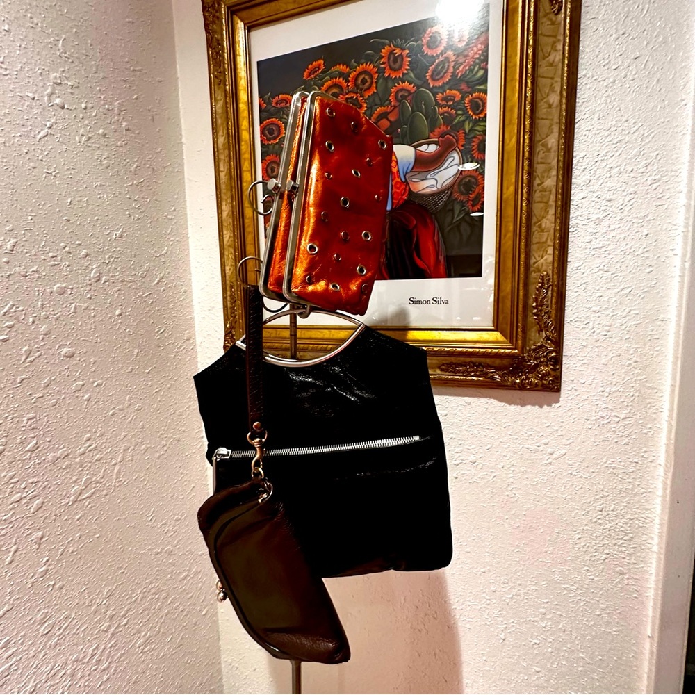 Trio of three HOBO wallet/wristlet purses in rich orange, black and brown.